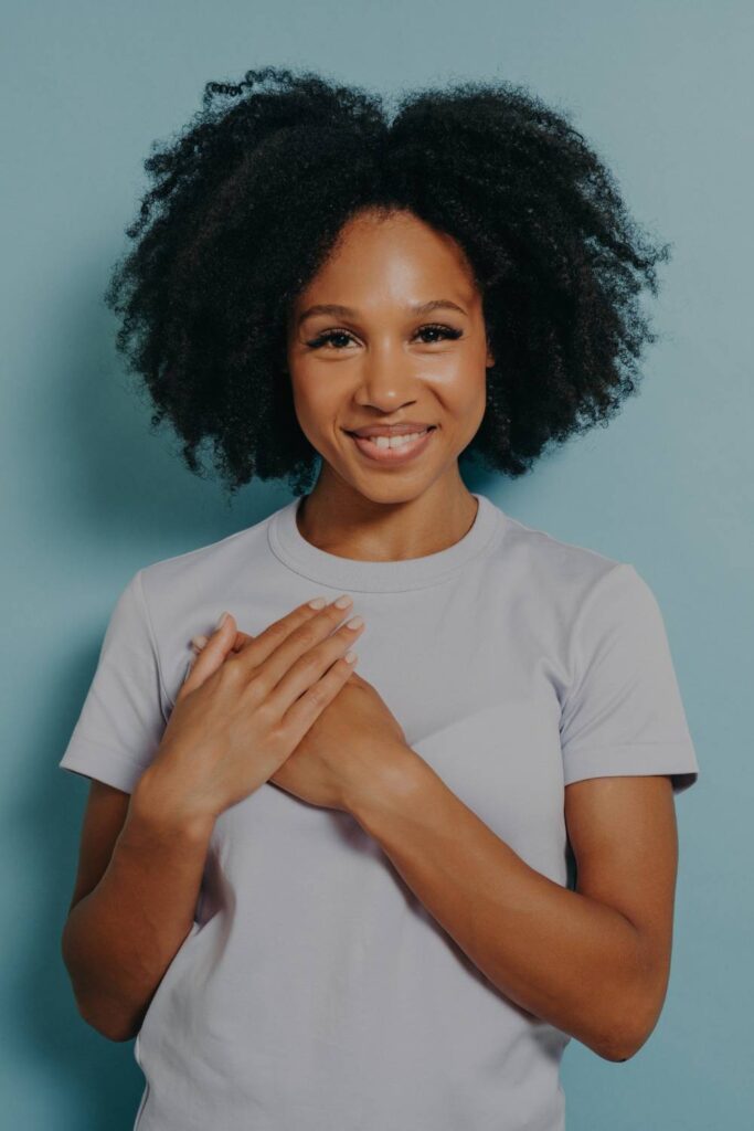 woman smiling and being grateful for her spiritual and personal growth
