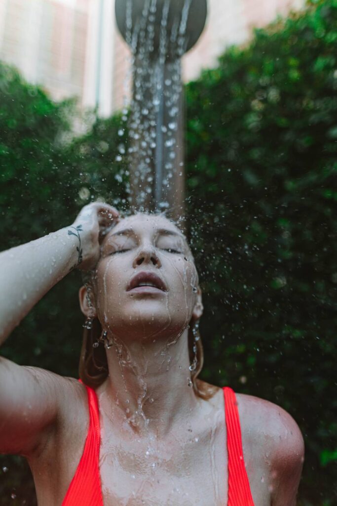 woman showering in nature peacefully