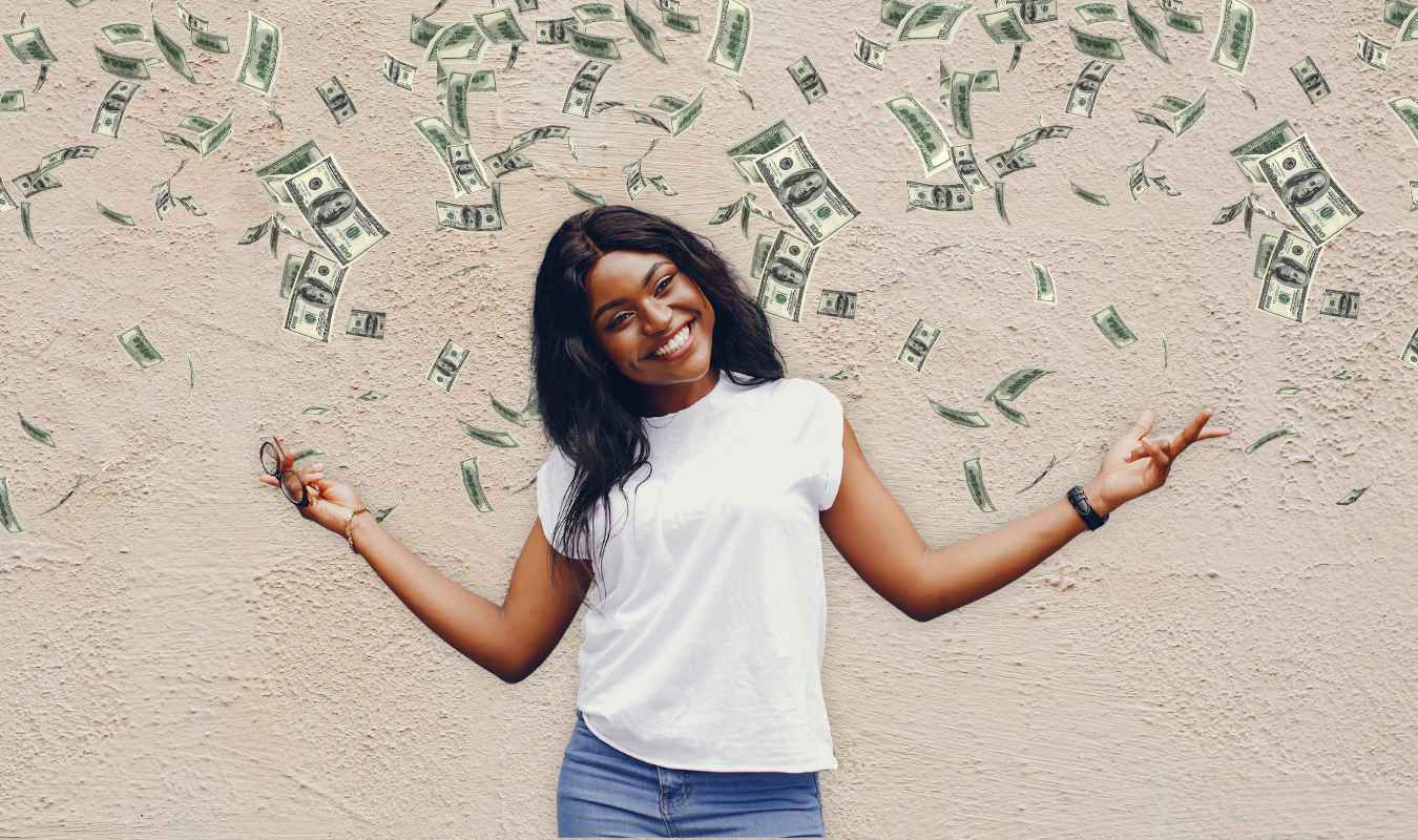 Happy woman surrounded by falling money representing abundance and how to manifest money successfully