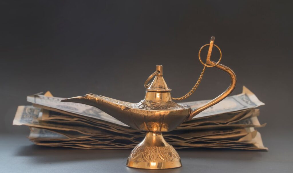 an image of a magic lamp sitting next to a large pile of money, symbolizing a guide on how to manifest step by step