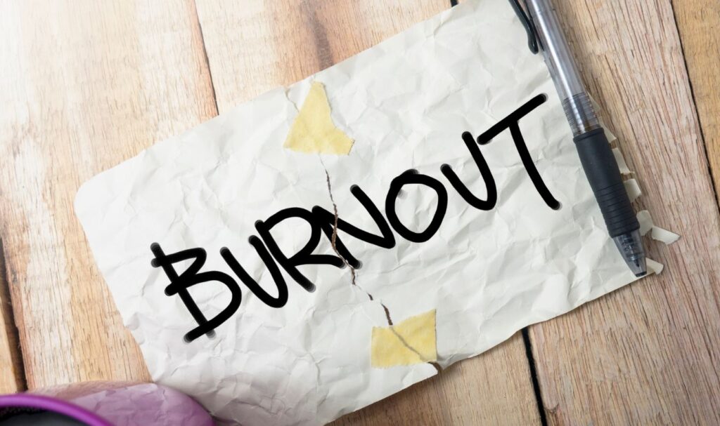 an image showing a piece of paper with the word 'burnout' written on it