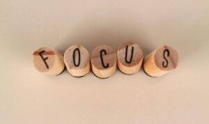 Wooden blocks spelling the word focus on a neutral background